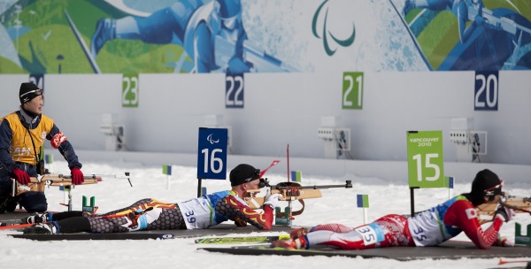 photograph athletes in prone position at firing range