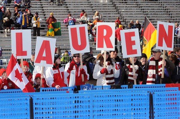 photograph of six fans with signage spelling LAUREN