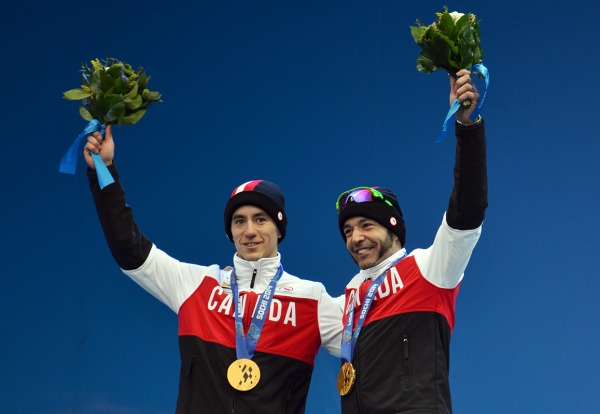 photograph of Brian McKeever and guide Graham Nishikawa with gold medals