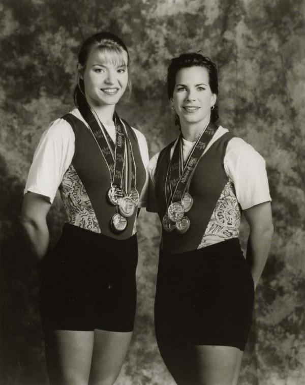 photograph of Kathleen Heddle and Marnie McBean wearing their four Olympic medals