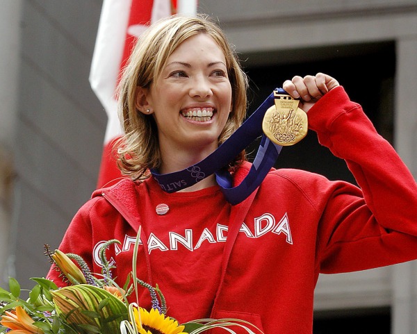 photograph of Beckie Scott holding gold medal