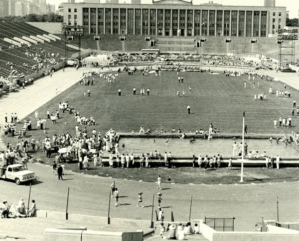 Photo of Soldier Field with a pool in the foreground and participants throughout the field and spectators in the stands