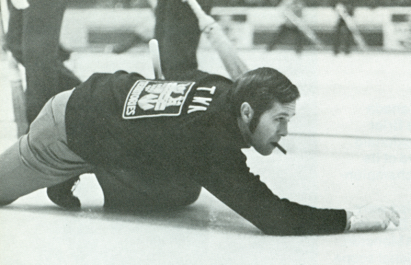 photograph Don Twa kneeling with one arm on ice