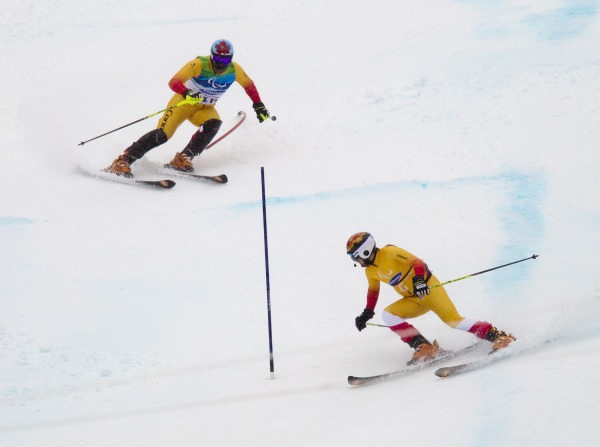 two skiers racing with front skier on radio