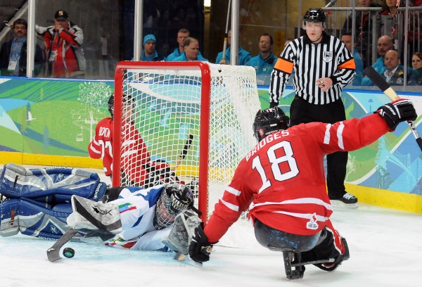 photograph of Billy Bridges attempting goal in sledge hockey