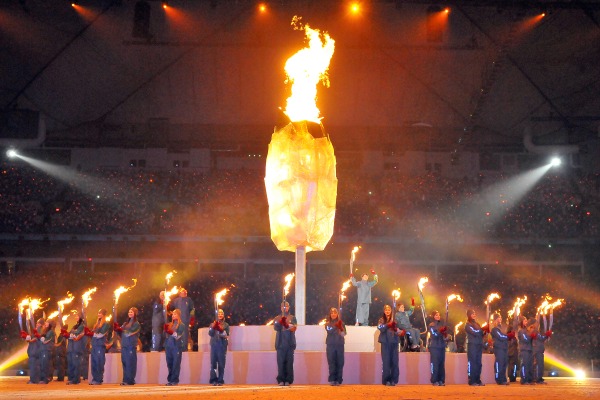 photograph of lit cauldron surrounded by torchbearers at the 2010 Paralympic Winter Games