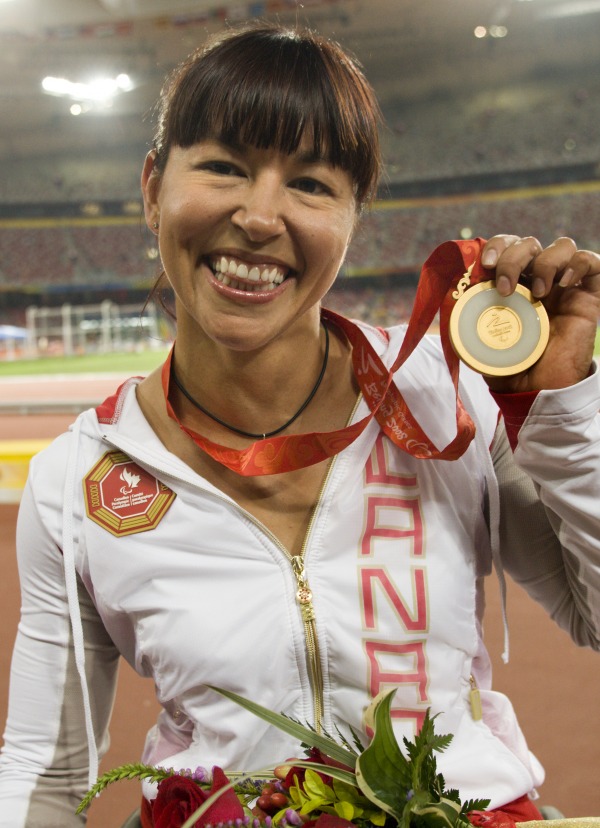 photograph of Chantal Petitclerc holding gold medal from Beijing