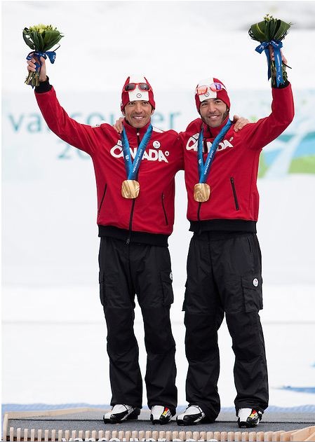 Brian and Robin McKeever with gold medals on podium